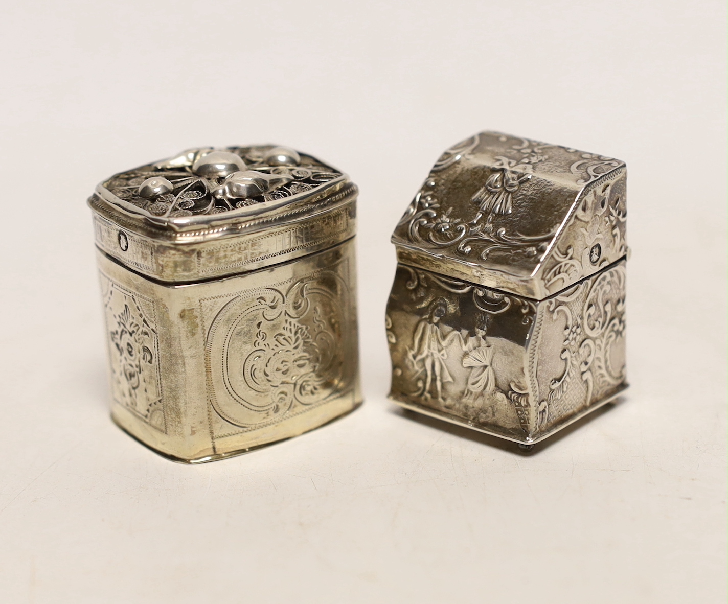 Two 19th century Dutch white metal snuff boxes, one of bureau form, on ball feet, 39mm.